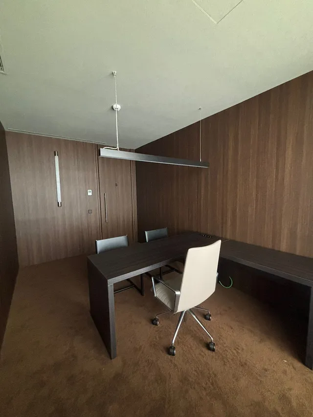 Despacho con revestimiento de madera oscura en paredes